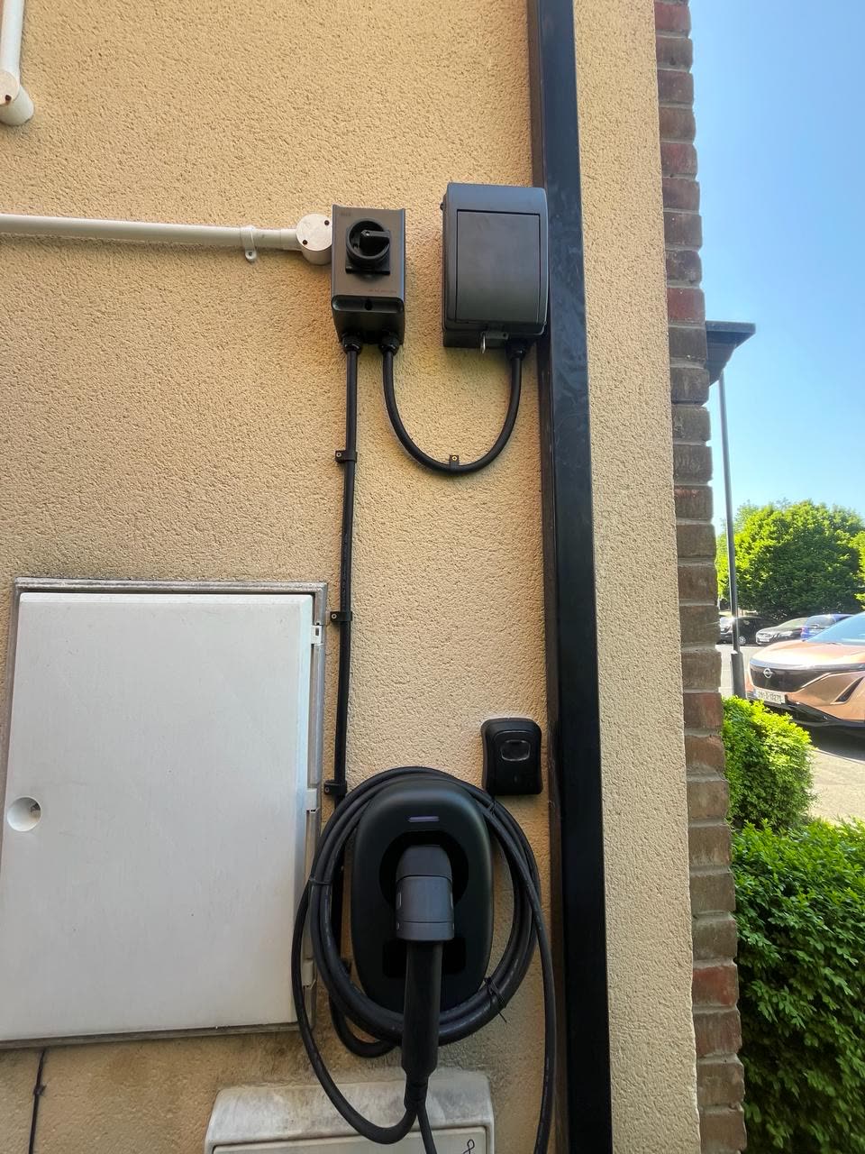 Tethered EV charger with meter and isolator