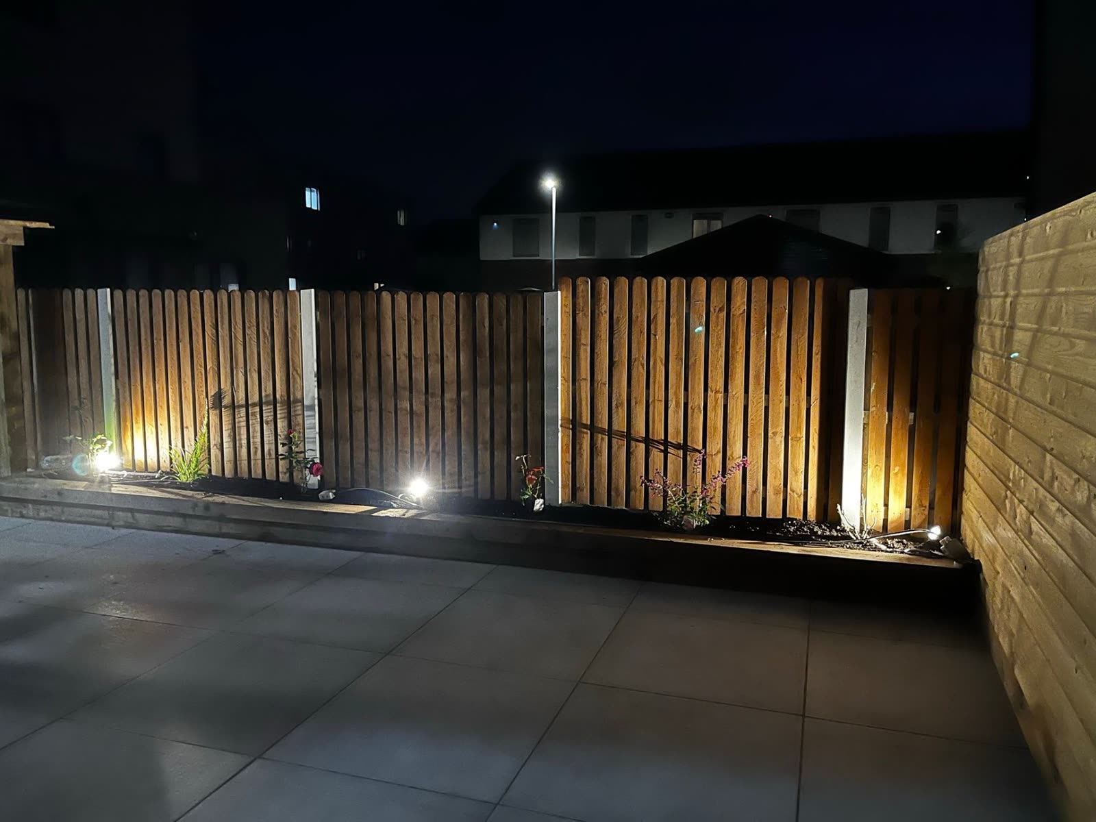 Garden fence spotlights at night